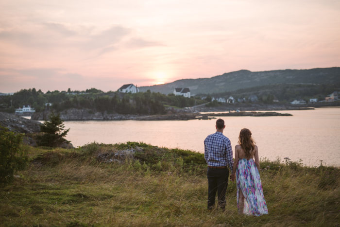 Couple overlooks sunset in Brigus Newfoundland and Labrador during an engagement session