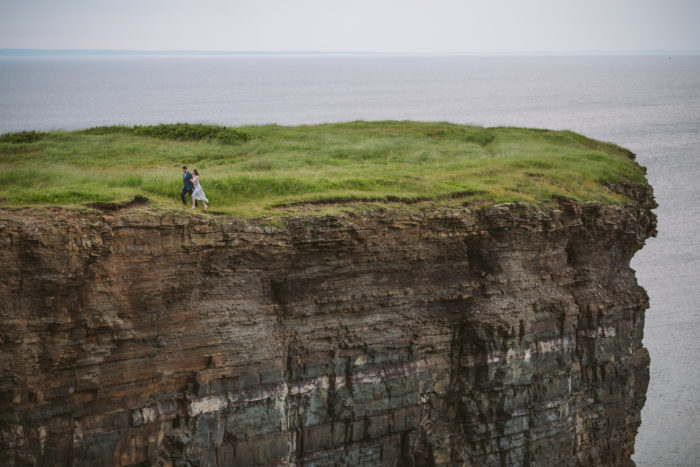Couple walking on top of the world during engagement session on Bell Island Newfoundland and Labrador