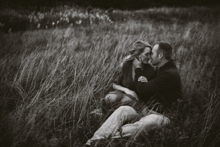 Engagement session in grassy field at Cape Spear Newfoundland and Labrador