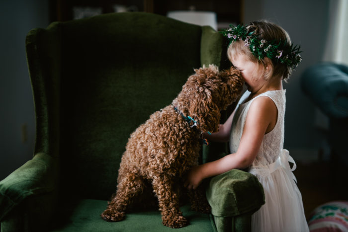 Miniture Poodle gives Flower girl a kiss on the wedding day