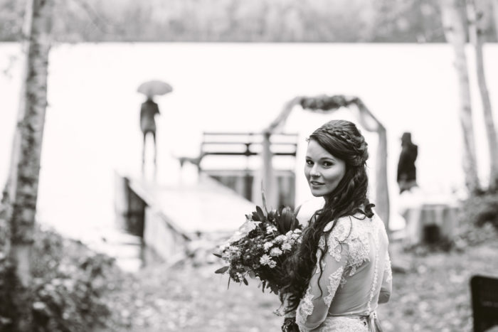 Bride walks towards her groom during a rainy first look in Central Newfoundland and Labrador