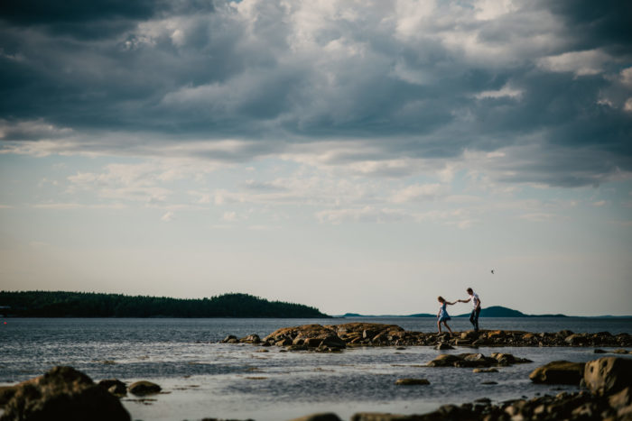 Climbing rocks at an engagement session in Lewisporte Newfoundland and Labrador